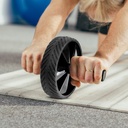 Close-up of a man doing ab training with the AsVIVA Ab Roller Fit AW1 on a mat